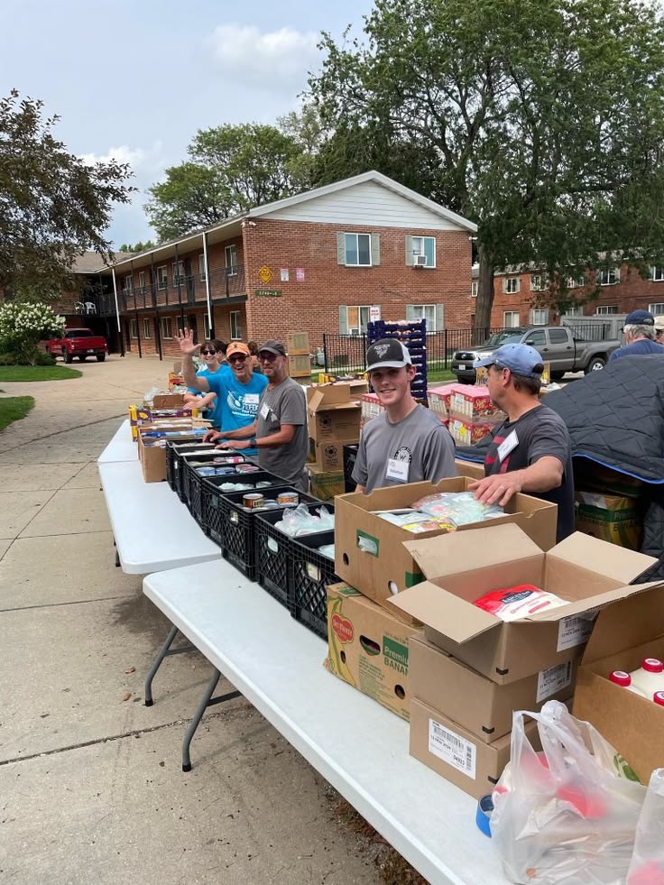 Volunteers serving at a row of outreach tables